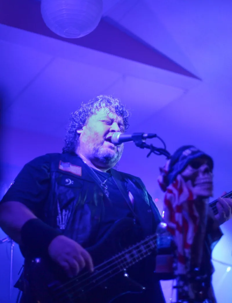 Bassist singing under blue light